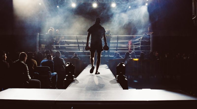 man standing and walking going on boxing ring surrounded with people — Photo by Attentie Attentie on Unsplash